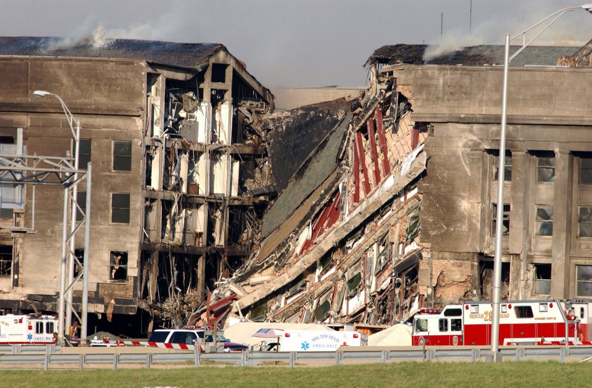 Damage to the western wall of the Pentagon on September 11, 2001, with emergency crews working at the site