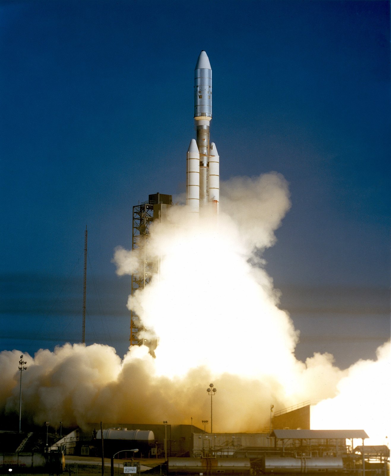 A Titan IIIE rocket lifting off from Launch Complex 41 at Cape Canaveral in a cloud of white exhaust