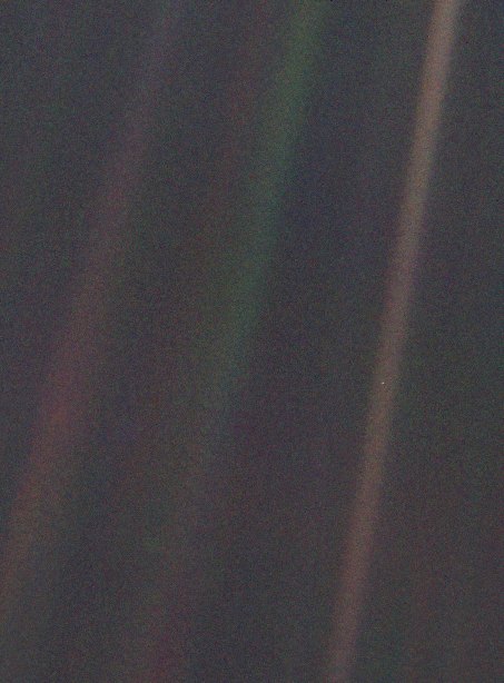 The Pale Blue Dot photograph: a dark field crossed by bands of scattered sunlight, with Earth as a tiny bluish speck